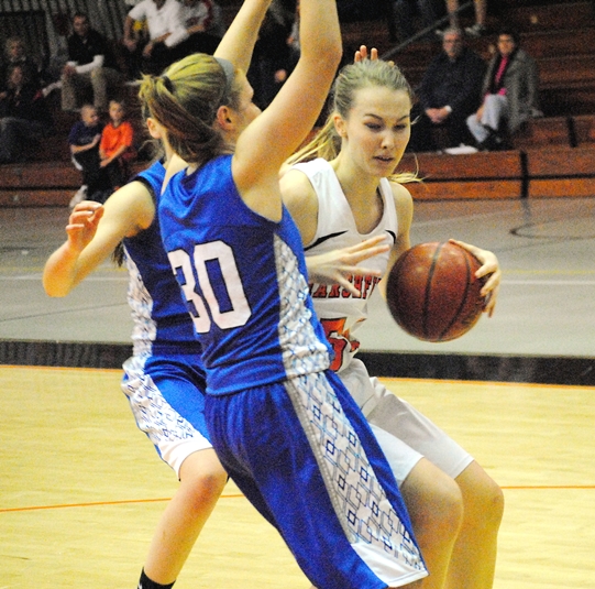 Marshfield's Ellie Fehrenbach drives inside against Merrill's Lindsay Krueger during Friday's Wisconsin Valley Conference girls basketball game at Marshfield High School. (Photo by Paul Lecker/MarshfieldAreaSports.com)