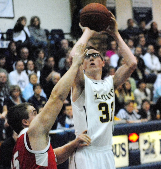 Marshfield Columbus Catholic's Jacob Puent puts up a shot over Spencer's Miles Weber during a Cloverbelt Conference East Division boys basketball game Thursday at Columbus Catholic High School. (Photo by Paul Lecker/MarshfieldAreaSports.com)