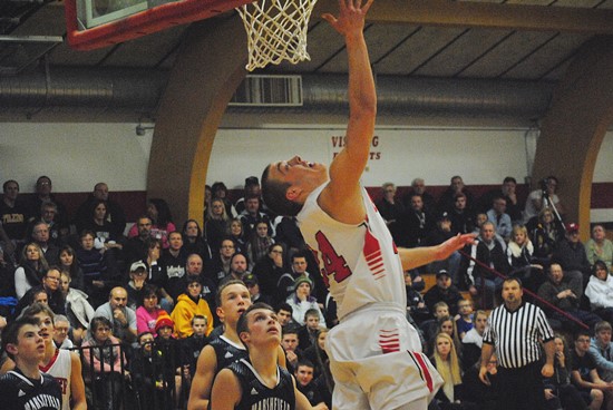 Spencer's Ryan Busse goes under the basket to make a layup late in the first half of the Rockets' loss to Columbus Catholic on Thursday at Spencer High School. (Photo by Paul Lecker/MarshfieldAreaSports.com)