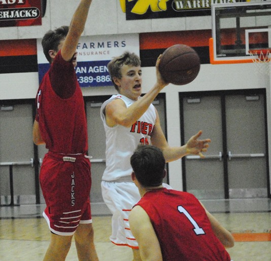 Marshfield junior guard Alec Hinson dishes a pass around the Wausau East defense during the Tigers' win on Friday at Marshfield High School. (Photo by Paul Lecker/MarshfieldAreaSports.com)