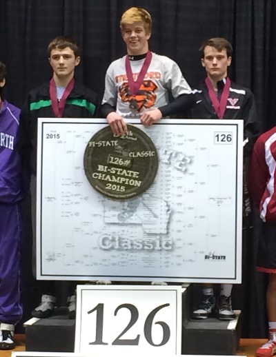 Stratford wrestler Jeremy Schoenherr, middle, celebrates his recent title at the Bi-State Classic in La Crosse. Schoenherr was voted as the WDLB-WOSQ Radio & MarshfieldAreaSports.com December High School Athlete of the Month. (Photo by Bryce Ford/Stratford Wrestling)