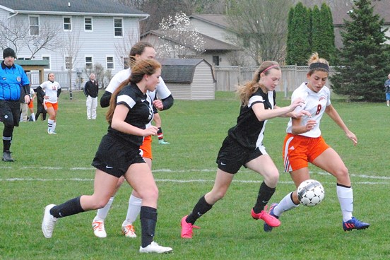 Marshfield's Maddie Haessly, right, tries to chase down a ball during the first half of the Tigers' game against Stevens Point on Tuesday at Griese Park. (Photo by Paul Lecker/MarshfieldAreaSports.com)